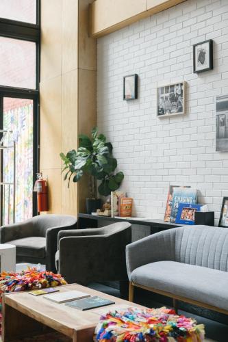 a restaurant with couches and a table and chairs at Orchard Street Hotel in New York