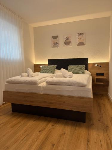 two beds in a bedroom with wooden floors at Be Grand Apartments Rust in Rust