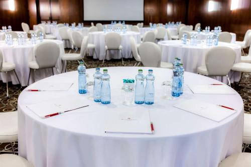 a group of tables and chairs with bottles on them at NH Collection Prague Carlo IV in Prague
