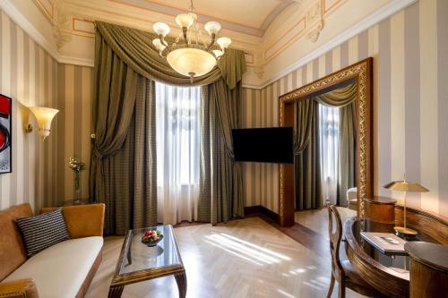 a living room with a couch and a table at NH Collection Prague Carlo IV in Prague