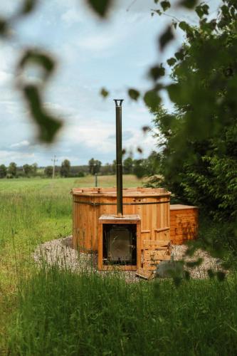 a woodburning stove in a field in a field at Płachty in Liniewo