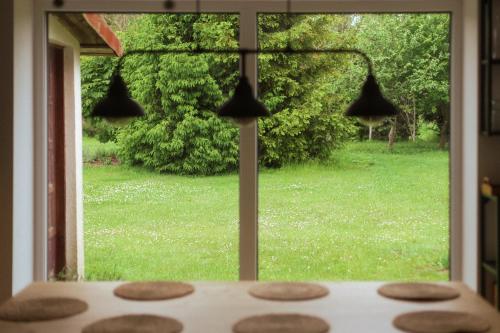 a view of a yard from a window with bells at Płachty in Liniewo