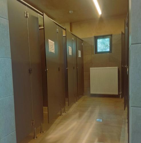 a row of lockers in a bathroom with a window at ATHENS MOTORHOME park RV WINNEBAGO in Pallíni