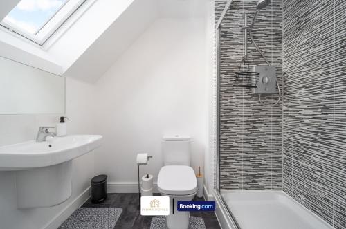 a bathroom with a toilet and a sink and a shower at 3 Bedroom House By The Yuma Homes Short Lets & Serviced Accommodation In Kent With Wifi & Parking in Ashford