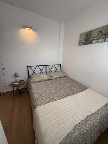 a small bedroom with two beds and a table at Mar y Sol in Empuriabrava