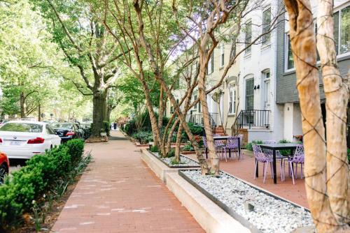 a brick sidewalk in front of a house with trees at The River Inn in Washington