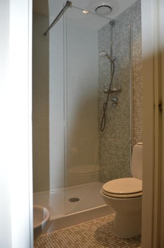 a bathroom with a toilet and a glass shower at Blue Dream Hotel in Monselice