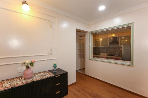 a room with a vase on a dresser and a mirror at Apple Tree Apartments Koregaon Park in Pune