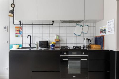 a kitchen with a sink and a stove at Modern Luxury Apartment -Prime South Yarra Location, Melbourne in Melbourne