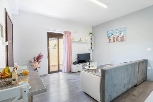 a living room with a couch and a table at Cozy Guesthouse in Koskinou