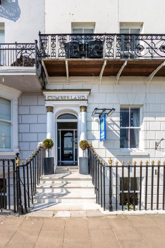 a building with a balcony on top of it at The Cumberland in Weymouth