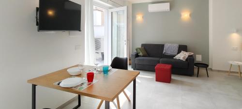 a living room with a table and a couch at Casa Quadrifoglio - Spalavera in Intra
