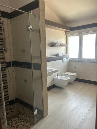 a bathroom with a glass shower and a toilet at Apartmani prenj 1 i 2 centar in Konjic