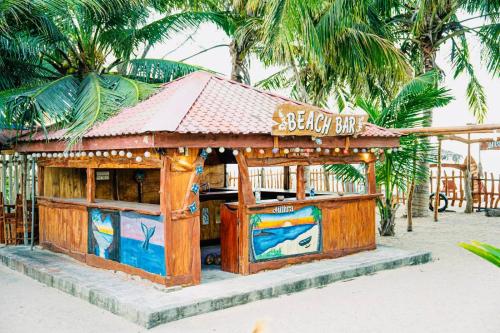 a small building with a seafood bar on the beach at Mithra Paradise Beach Hotel in Nilaveli