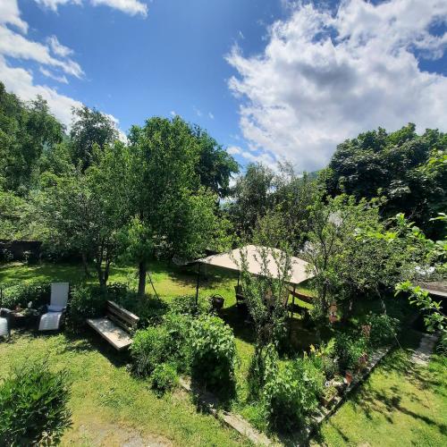 a view of a garden with two chairs and trees at Apartments Gio-Nika in Stepantsminda