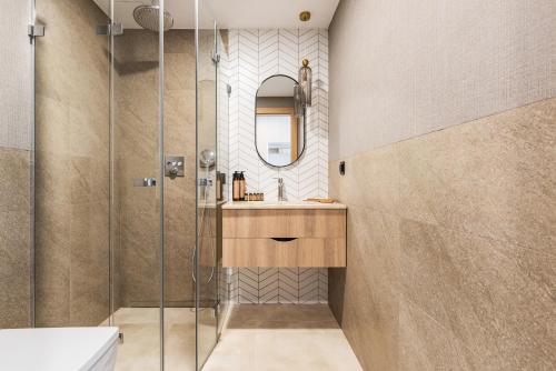 a bathroom with a shower and a sink at Blue&Green Masurian Hotel in Węgorzewo