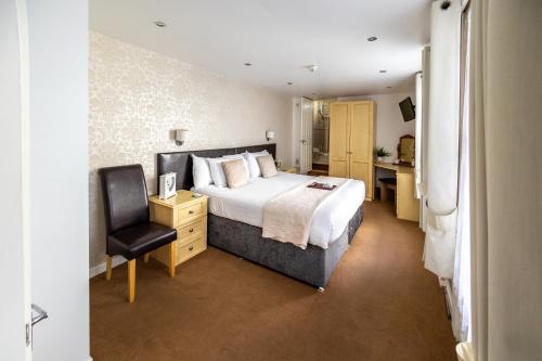 a bedroom with a bed and a desk and a chair at The Cumberland in Weymouth