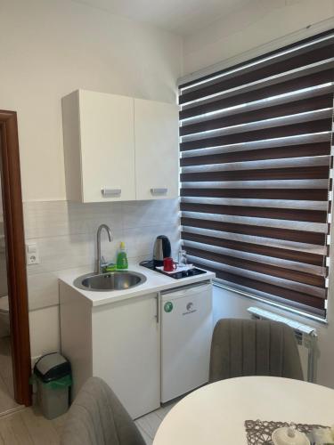a small kitchen with a sink and a window at Apartmani prenj 1 i 2 centar in Konjic
