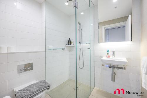 a bathroom with a glass shower and a sink at MetaWise Sydney CBD Luxury City view 2BED Apartment in Sydney