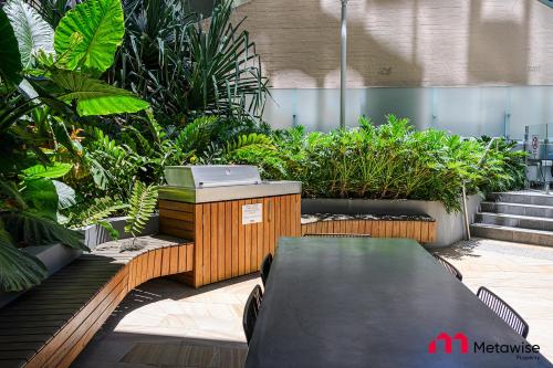 a garden with plants and a skateboard on a patio at MetaWise Sydney CBD Luxury City view 2BED Apartment in Sydney