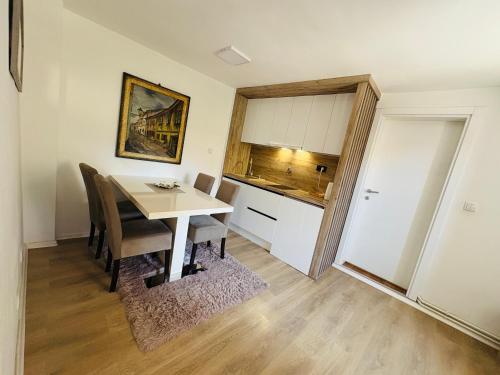 a kitchen and dining room with a table and chairs at Apartment Irma in Sarajevo