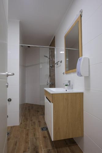 a bathroom with a sink and a mirror at Apartmani Lepojevic in Prokuplje