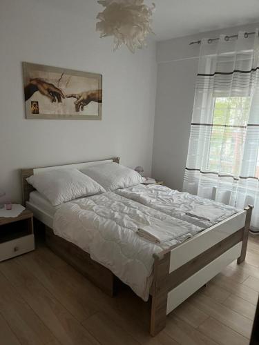 a bedroom with a large bed in a room at Apartament Polanki E207 in Kołobrzeg