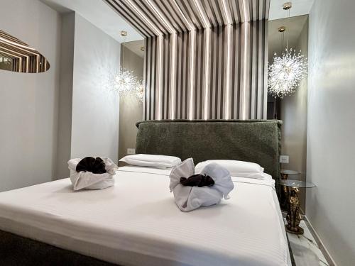 a bedroom with a bed with two bags on it at Cloud Nine Airport Residence in Cluj-Napoca
