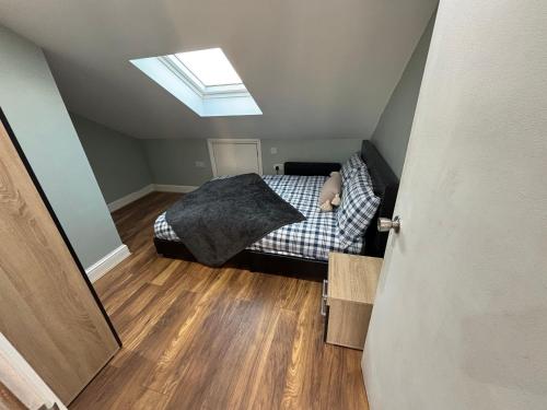 a bedroom with a bed and a skylight at 47a 2bedroom harrow central in Harrow