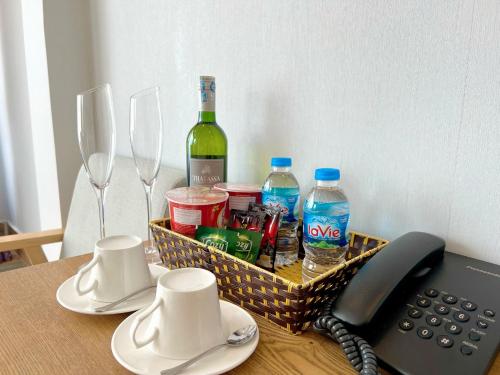 a basket with a bottle of wine and a telephone at Mường Hoa Valle Home in Sa Pa
