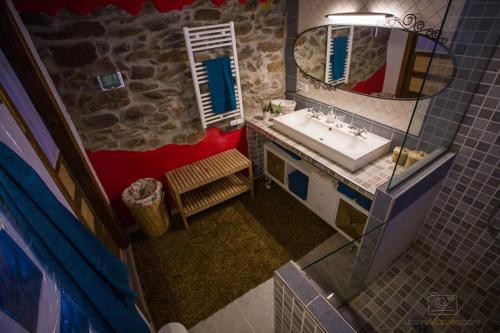 an overhead view of a bathroom with a sink and mirror at La Casa Roja de Quirós 