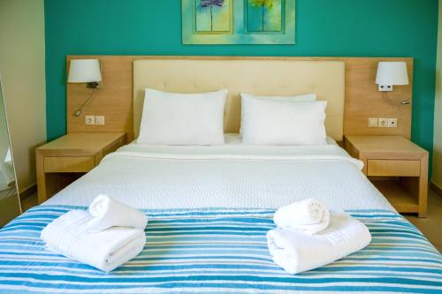 a bedroom with a bed with towels on it at Princess Hotel in Lassi