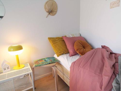 a bedroom with a bed and a table with a lamp at Tikkurila studio for 4 people next to the airport, private parking in Vantaa