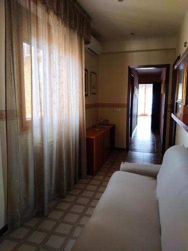 a room with a bed and a sink and a window at Cullati dal Mare Apartments in Pozzallo