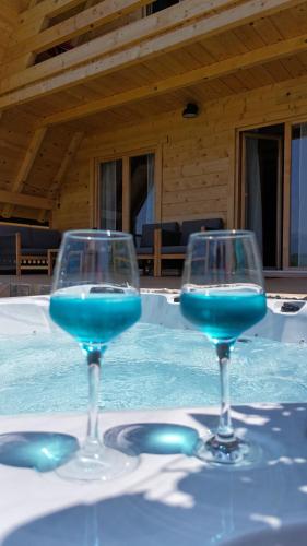 two glasses with blue liquid sitting on a table at Planinska kuća za odmor Aneva in Sveti Rok