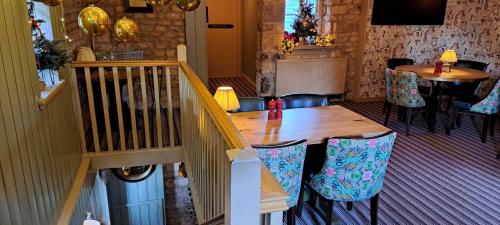 a wooden table and chairs in a room at Crown Hotel in Stamford