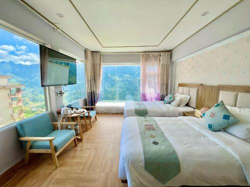 a hotel room with two beds and a large window at Mường Hoa Valle Home in Sa Pa