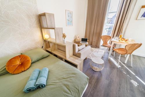 a bedroom with a bed with two pillows on it at "Aux Grandes Ecoles" Studio Premium cœur de Poitiers in Poitiers