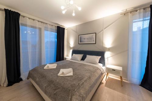 a bedroom with a bed with two white napkins on it at Alba Family Home in Zadar