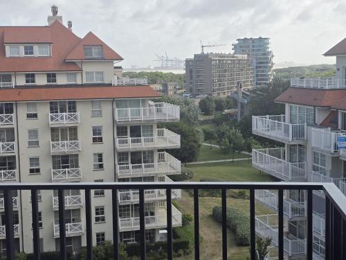 a view from the balcony of a apartment building at Stijlvol nieuwbouwappartement op wandelafstand zee - INCLUSIEF PARKEERPLAATS in Blankenberge