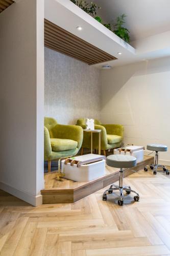 a waiting room with green chairs and tables at Roganstown Hotel & Country Club in Swords
