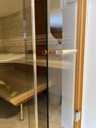 a glass door with a handle in a room at Lifestyle & Spa Hotel Grächerhof in Grächen