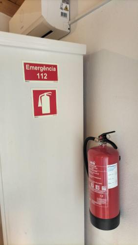 a fire hydrant in a room with a sign on the wall at Casa Dominó in Aldeia do Mato