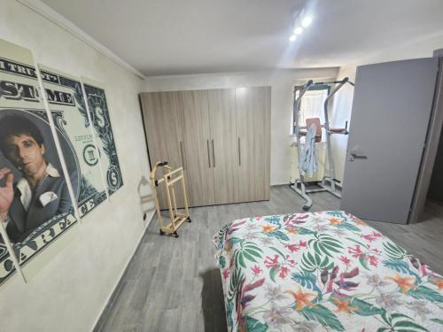a hospital room with a bed and a poster of a man at Casa Magica in Pozzo