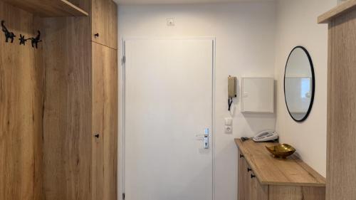 a bathroom with a white door and a mirror at Appartementhaus Birkenwald in Seefeld in Tirol