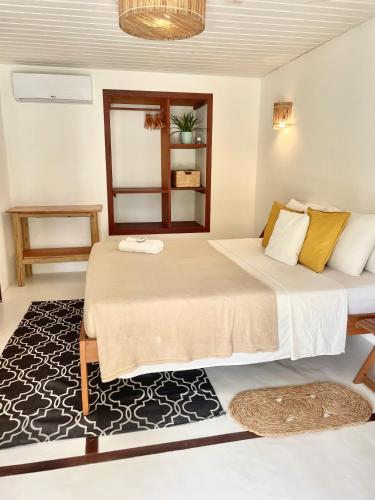a bedroom with two beds and a rug at Villa Caribou in Icaraí