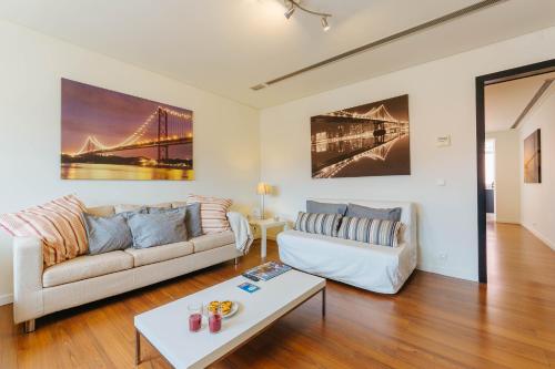 a living room with a couch and a table at Rent4Rest Lisbon Family & Friends apartment in Roma Avenue in Lisbon