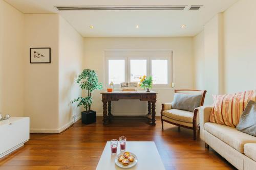 a living room with a couch and a table at Rent4Rest Lisbon Family & Friends apartment in Roma Avenue in Lisbon