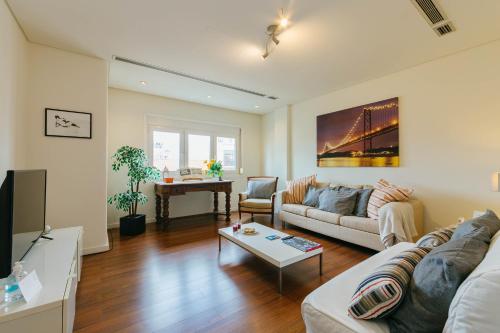 a living room with a couch and a table at Rent4Rest Lisbon Family & Friends apartment in Roma Avenue in Lisbon