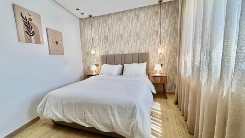 Ένα ή περισσότερα κρεβάτια σε δωμάτιο στο E19 Appartement moderne et calme à Maarif Casablanca